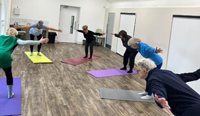 Six people partaking in yoga