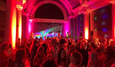 Dark but colourful image of a funkytown disco party