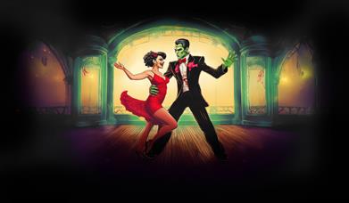 Frankenstein and woman in red dress dancing