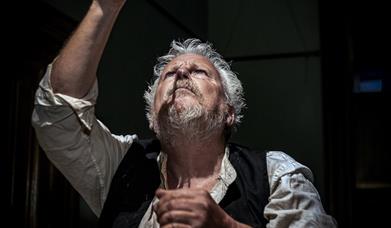 Krapp resting head against record player