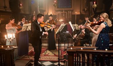 The Piccadilly Sinfonietta performing in a candlelit church