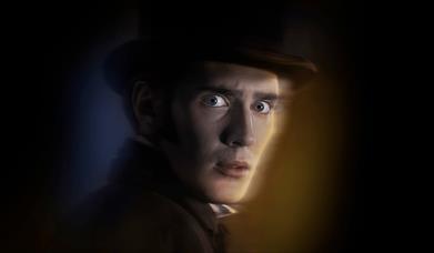 Scared looking man in smart coat and top hat