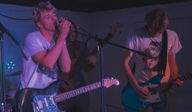 2 people playing in a band